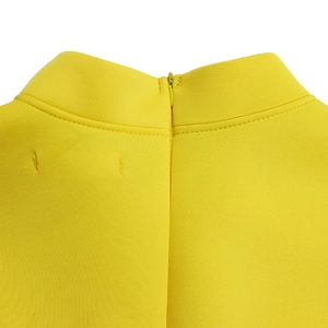 Close-up of lemon yellow high collar with concealed zipper and neat back stitching