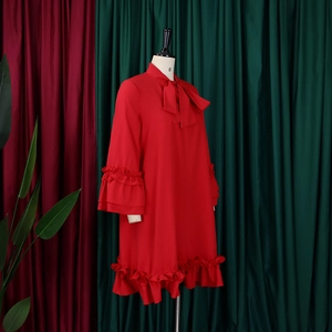 Detail of red tiered ruffle hem and bow tie neckline on casual loose dress