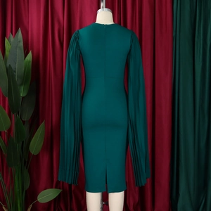 Detail of dark green dress with pleated cape sleeves and hidden back zipper closure