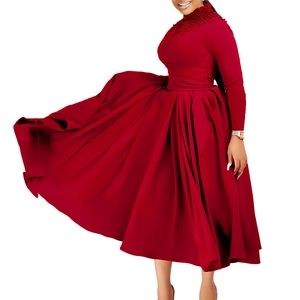 Detailed view of dark red evening gown featuring high neck and intricate beaded accents