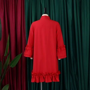 Rear view of red dress with layered ruffle sleeves and hemline on a mannequin