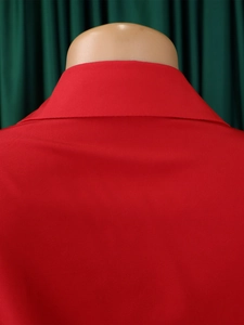 Close-up of the red lapel collar and fine twill fabric texture on a fashion dress