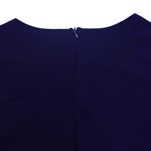 Detail of navy blue pleated dress featuring a crew neck and seamless invisible zipper