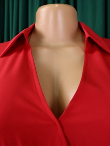 Detail of red deep V-neck shirt showing collar design and crisp fabric texture