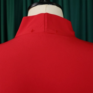 Detail of red stand collar dress with professional stitching on a white mannequin