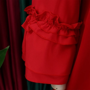 Detail of red tiered ruffle cuffs and double-layered stitching on long sleeve dress