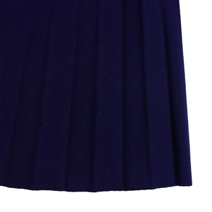 Detailed close-up of dark blue pleated fabric showing fine texture and clean hem edges