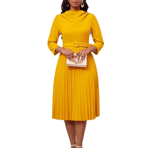 Detail view of yellow pleated midi dress with high neck, matching belt and 3/4 sleeves