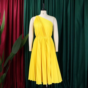 Detailed view of the yellow pleated one-shoulder dress with waist tie on mannequin