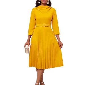 Detail of elegant yellow pleated dress with stand collar and matching waist belt