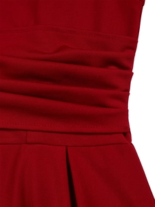 Close-up of ruched waist details and pleated fabric on this elegant dark red dress