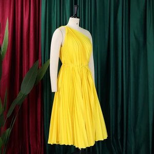 Detailed pleats on a bright yellow one-shoulder A-line dress with waist belt