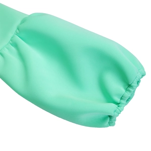 Detail of mint green puff sleeve with elastic cuff and textured weave fabric