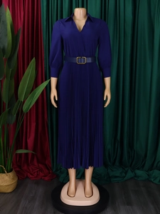 Detail view of navy blue pleated dress featuring a V-neck lapel and golden waist buckle