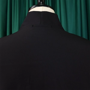 Detail of black stand collar and shoulder stitching on a solid casual tunic dress
