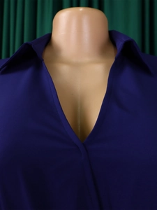 Close-up of deep V-neckline and flat lapel on a navy blue woven dress for women