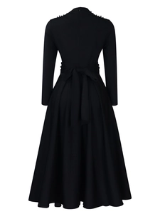 Detail of elegant black high-neck dress showing shoulder beads and waist bow tie back