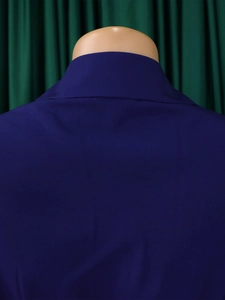 Macro detail of dark blue dress fabric texture and back shoulder stitching on mannequin