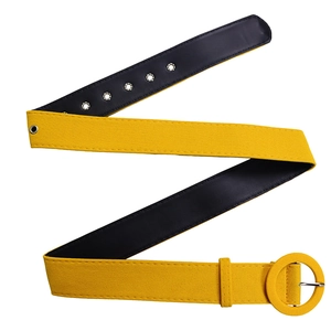 Detail of yellow pleated dress belt with round fabric buckle and silver metal eyelets