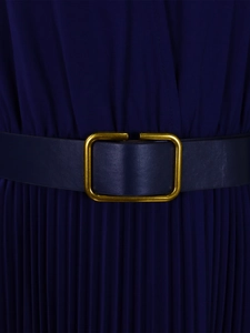 Detail of navy blue pleated dress featuring a slim leather belt with a gold square buckle