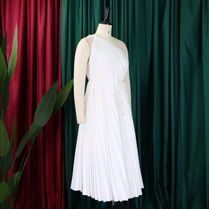 Detail of white pleated one-shoulder dress featuring delicate organza texture and waist drawstring