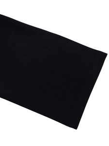 Detailed macro view of the high-quality double-stitched sleeve cuff on black dress