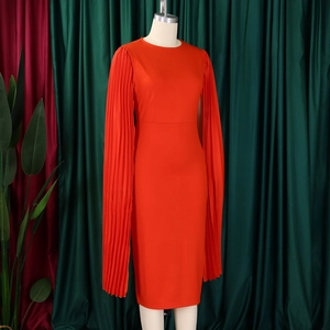 Close-up of orange-red midi dress featuring elegant pleated cape sleeves and round neck