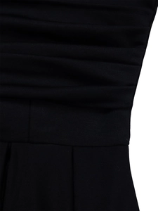 Close-up of horizontal pleats and waist design on an elegant black evening dress