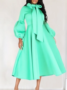 Elegant mint green puff sleeve maxi dress with high neck bow tie and flared waist design