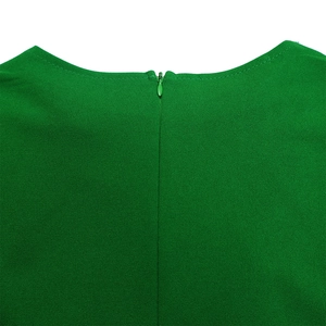 Detail of green dress neckline featuring a seamless hidden zipper and textured fabric