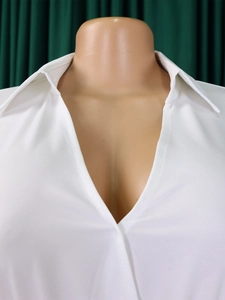 Close-up of white deep V-neck chiffon blouse on a mannequin with classic relaxed fit