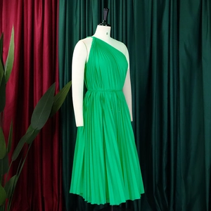 Detailed texture of vibrant green pleated one-shoulder maxi dress in soft chiffon