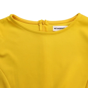 Close-up of yellow pleated dress round neckline and hidden back zipper detail