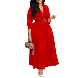 Close-up of red pleated dress with deep V-neck and waist belt with golden buckle