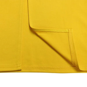 Detailed close-up of bright yellow pleated fabric with high-quality double-needle stitching