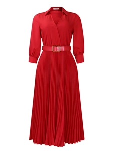 Detail of red pleated midi dress with gold buckle belt and elegant lapel neckline