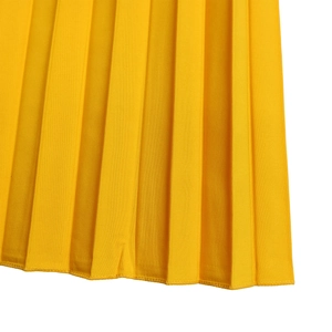 Detail of yellow pleated fabric showing fine vertical texture and precision stitching