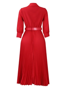Back view of a red long-sleeved pleated dress with a lapel collar and matching waist belt