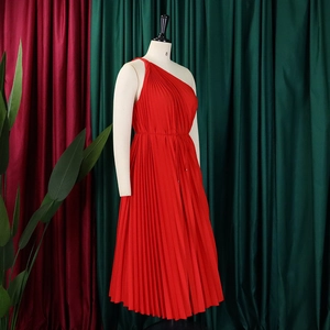 Detail of red one-shoulder pleated dress with waist drawstring and accordion folds