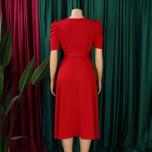 Back view of elegant red puff sleeve midi dress with matching waist belt on a mannequin