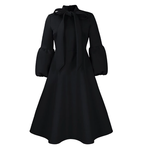 Detail of elegant bow neckline and puff sleeves on this plus size black dress