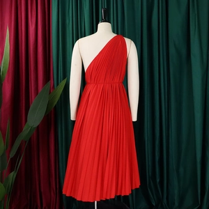 Detail of red one-shoulder pleated A-line dress with elegant waist tie and textured fabric