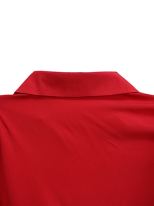 Detailed close-up of vibrant red turn-down collar with clean stitching and smooth fabric