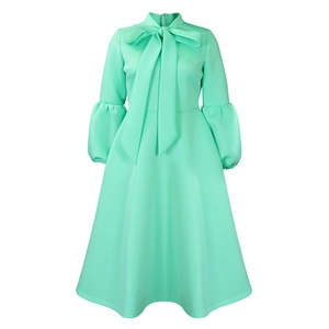 Detail of mint green pussy-bow neckline and elegant lantern sleeves on a vintage dress