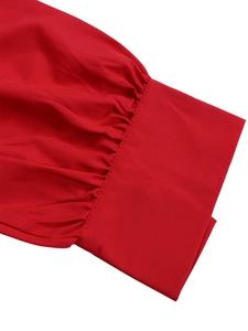 Detailed view of red lantern sleeve cuffs with fine pleats and high-quality stitching