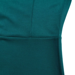Macro view of teal pleated knit fabric showing detailed stitching and fine texture