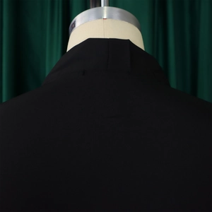 Detailed back view of the elegant black dress featuring a classic high neckline design