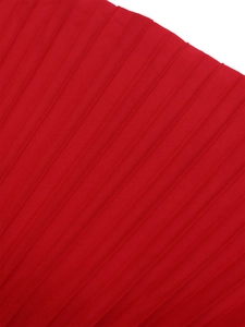 Macro shot of red pleated fabric texture with elegant accordion pleats and satin sheen