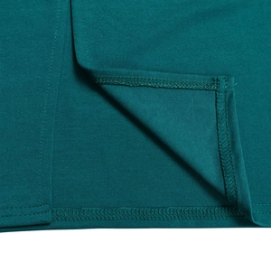 Macro detail of high-quality double-line stitching and teal fabric texture on evening dress