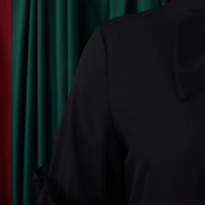 Macro shot of black twill fabric detailing the ruffle sleeve seam and textured material